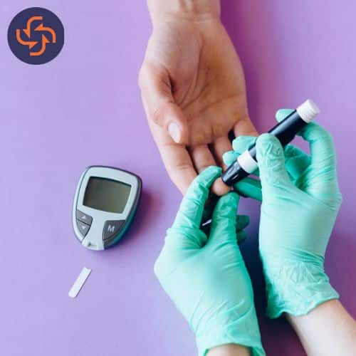 Gloved hands check blood sugar with a finger prick; glucose meter and strip nearby.