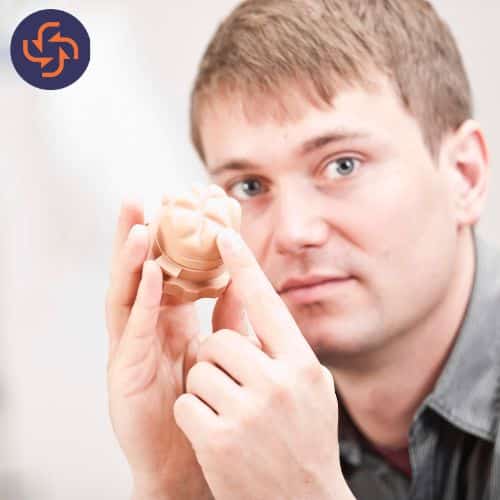 Man holding and pointing at a prostate model, representing benign prostatic hyperplasia (BPH).